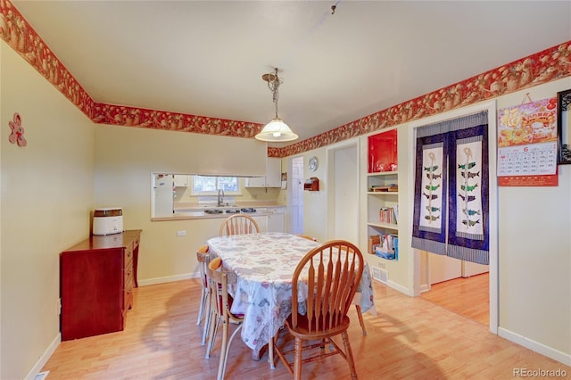 6971 S Valentia St, Centennial, CO 80112 - dining room with light wood finished floors and baseboards