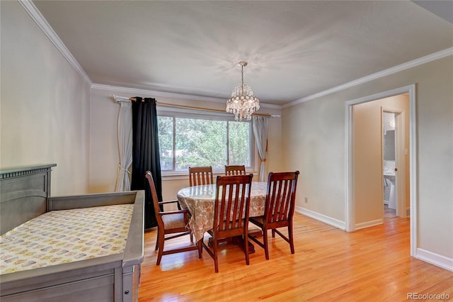 6971 S Valentia St, Centennial, CO 80112 - dining room with light wood finished floors, a chandelier, baseboards, and ornamental molding