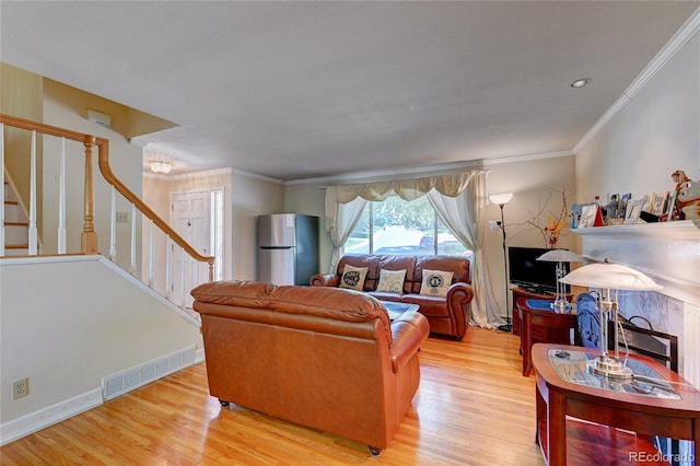 6971 S Valentia St, Centennial, CO 80112 - living area with stairway, light wood-style floors, and ornamental molding
