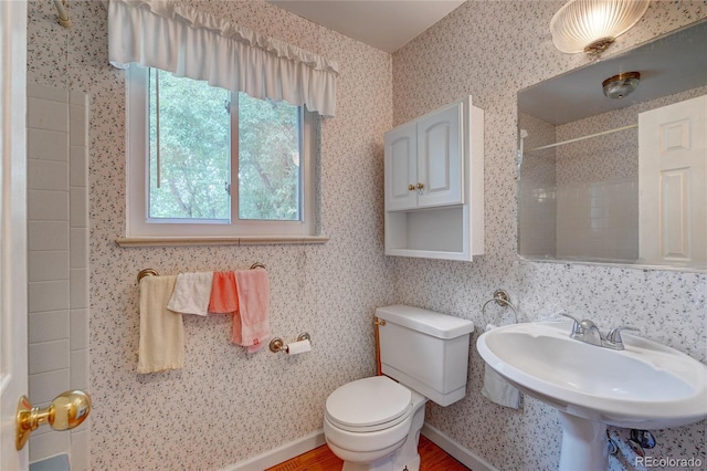 6971 S Valentia St, Centennial, CO 80112 - bathroom with toilet, a shower, wood finished floors, and a sink