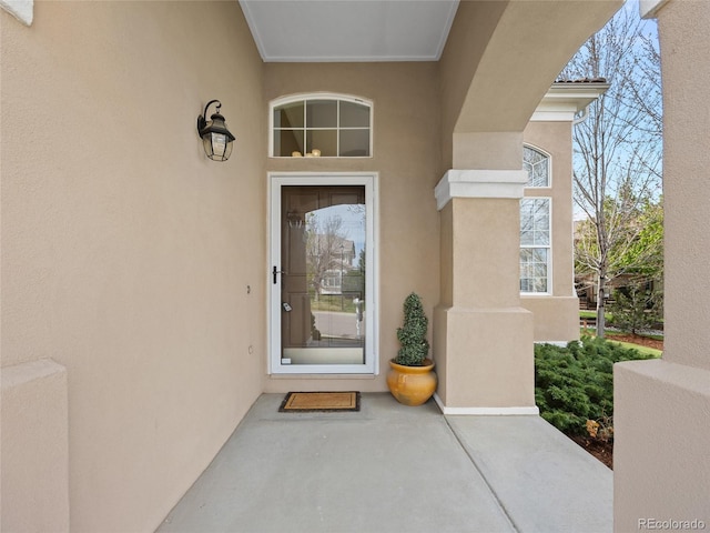 view of exterior entry with stucco siding