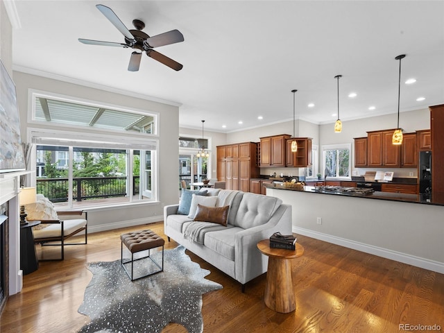 living area featuring crown molding, recessed lighting, a ceiling fan, and wood finished floors