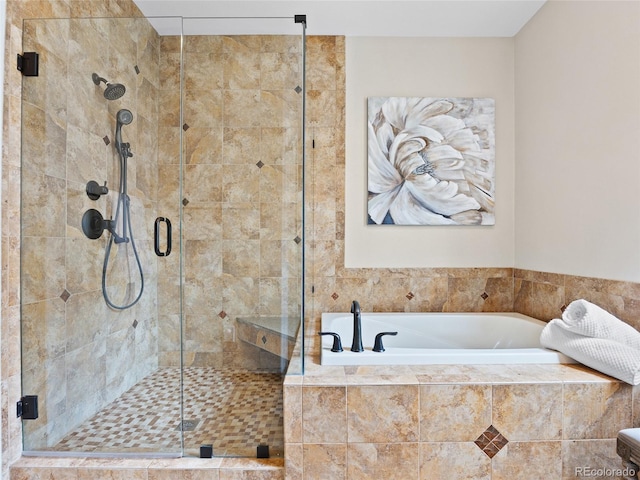 bathroom with a bath and a stall shower