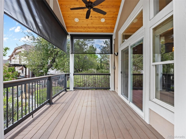 wooden terrace featuring ceiling fan