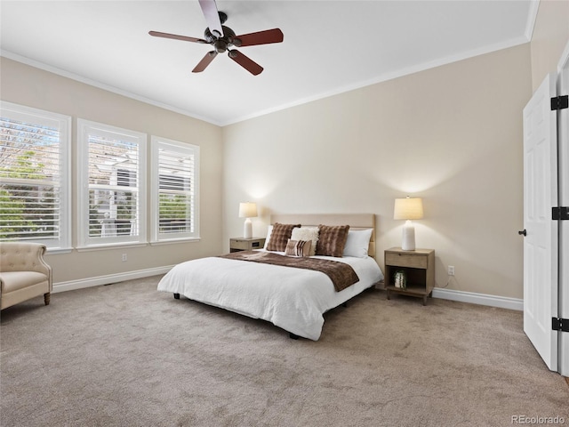 bedroom featuring crown molding, a ceiling fan, baseboards, and carpet