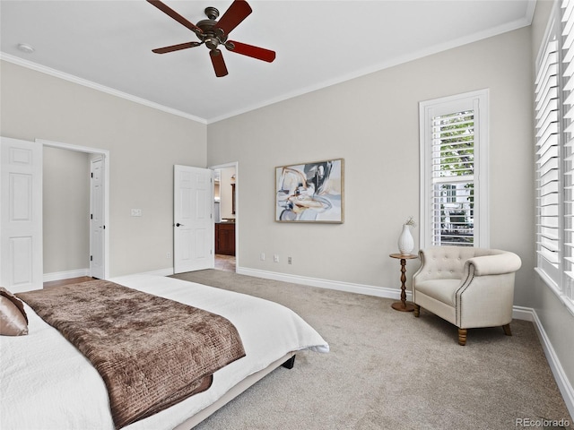 carpeted bedroom with crown molding, baseboards, and ceiling fan