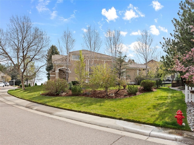 exterior space with a lawn and stucco siding