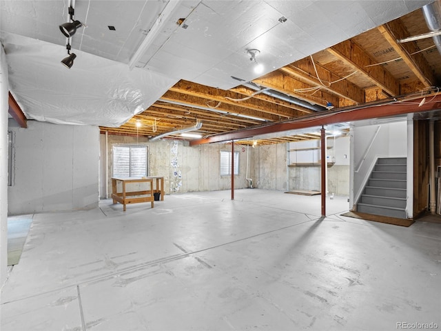 basement featuring stairs