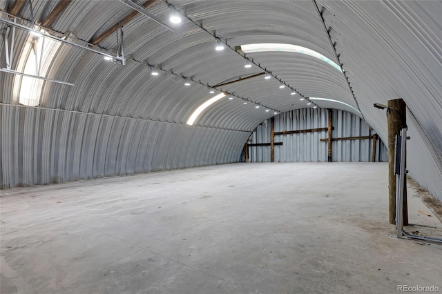 misc room featuring concrete flooring and lofted ceiling