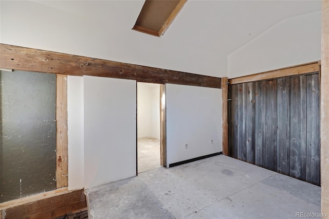spare room with vaulted ceiling