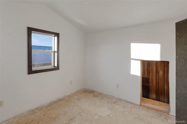 empty room featuring vaulted ceiling