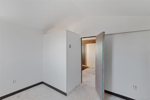 spare room featuring vaulted ceiling