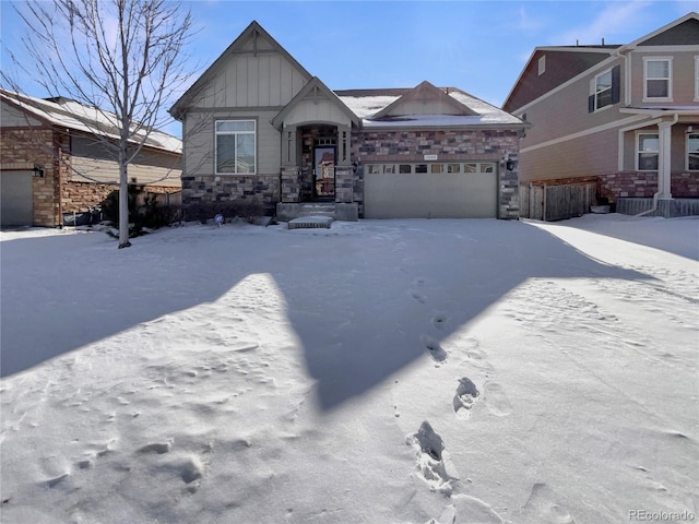 view of front of home featuring a garage, stone siding, and board and batten siding