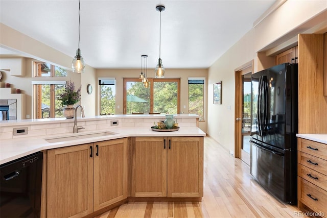 33095 Bergen Mountain Rd, Evergreen, CO 80439 - kitchen featuring black appliances, a sink, light wood-style floors, light countertops, and pendant lighting