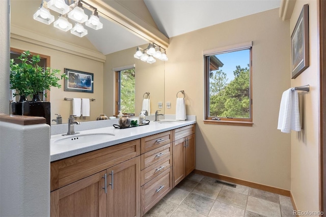 33095 Bergen Mountain Rd, Evergreen, CO 80439 - full bath with vaulted ceiling, double vanity, and baseboards