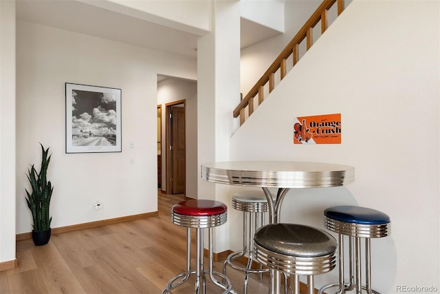 33095 Bergen Mountain Rd, Evergreen, CO 80439 - dining space featuring wood finished floors, stairway, and baseboards