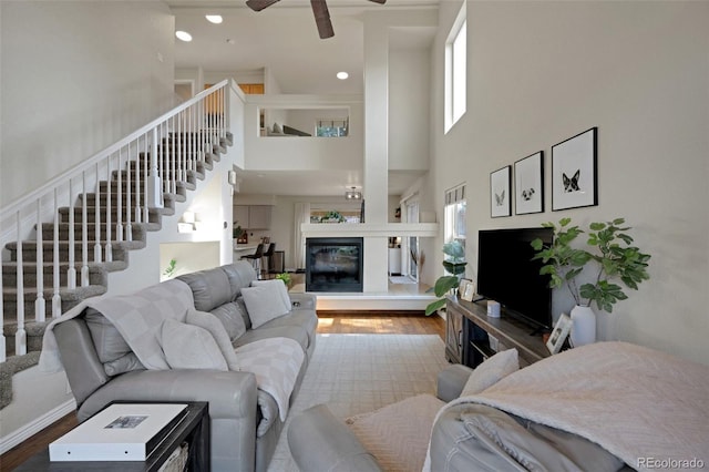 20000 Mitchell Pl Unit 9, Denver, CO 80249 - living area featuring plenty of natural light, stairs, wood finished floors, and ceiling fan
