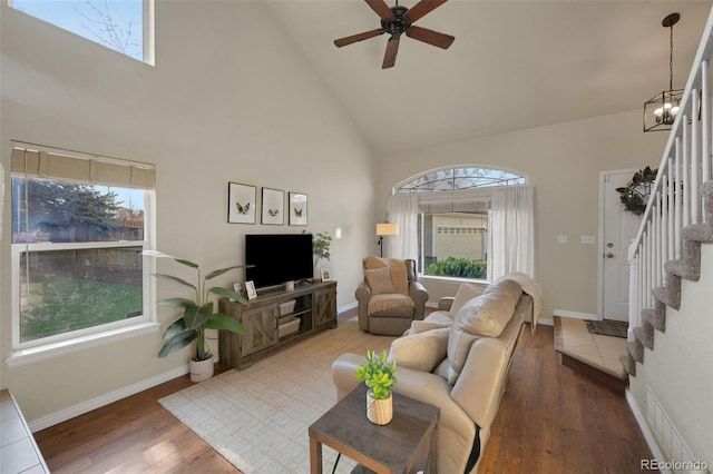 20000 Mitchell Pl Unit 9, Denver, CO 80249 - living room featuring wood finished floors, ceiling fan with notable chandelier, stairs, and a wealth of natural light