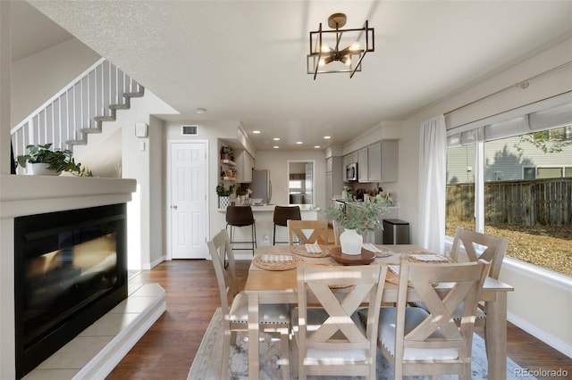 20000 Mitchell Pl Unit 9, Denver, CO 80249 - dining area featuring baseboards, dark wood-style flooring, and a healthy amount of sunlight