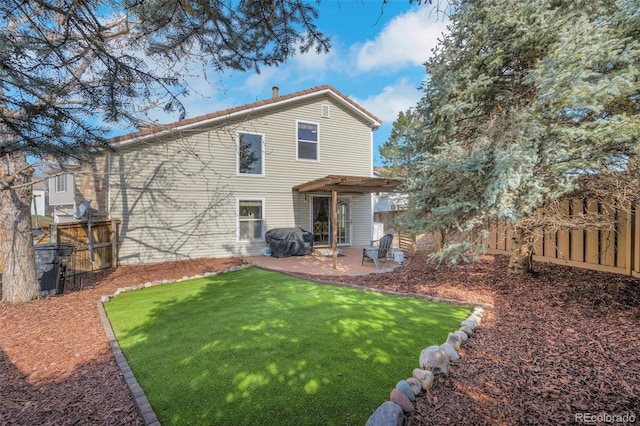 20000 Mitchell Pl Unit 9, Denver, CO 80249 - back of property featuring a fenced backyard, a yard, and a patio