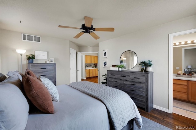 20000 Mitchell Pl Unit 9, Denver, CO 80249 - bedroom featuring ensuite bathroom, visible vents, baseboards, ceiling fan, and dark wood-style floors