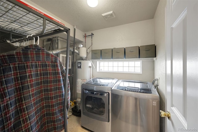 20000 Mitchell Pl Unit 9, Denver, CO 80249 - clothes washing area with water heater, a textured ceiling, visible vents, washer and dryer, and laundry area