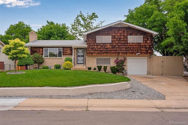 147 Wallace St, Northglenn, CO 80234 - split level home featuring concrete driveway, an attached garage, a chimney, and brick siding