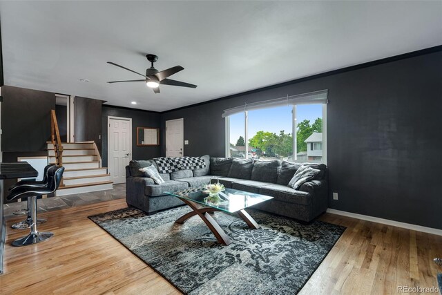 147 Wallace St, Northglenn, CO 80234 - living area featuring crown molding, wood finished floors, ceiling fan, stairs, and baseboards