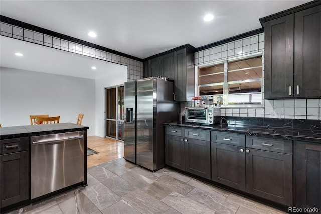 147 Wallace St, Northglenn, CO 80234 - kitchen featuring appliances with stainless steel finishes, backsplash, dark stone counters, and recessed lighting