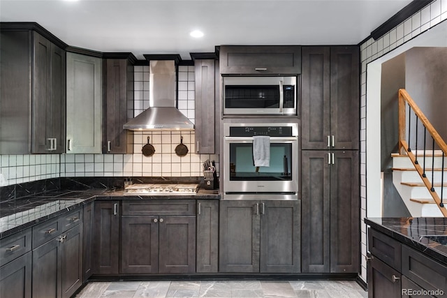 147 Wallace St, Northglenn, CO 80234 - kitchen featuring stainless steel appliances, wall chimney exhaust hood, tasteful backsplash, and dark stone counters