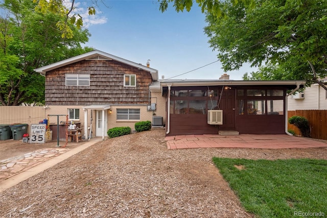 147 Wallace St, Northglenn, CO 80234 - back of property with a sunroom, brick siding, a patio area, and central AC unit