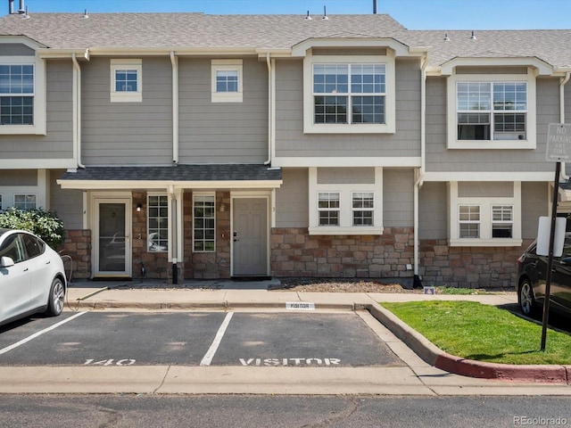 9024 Gale Blvd Unit 3, Thornton, CO 80260 - townhome / multi-family property with uncovered parking, stone siding, and a shingled roof