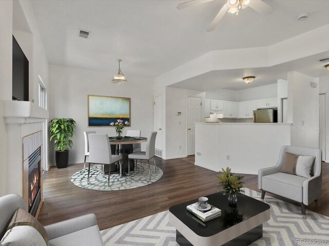 9024 Gale Blvd Unit 3, Thornton, CO 80260 - living area featuring a tile fireplace, wood finished floors, and ceiling fan