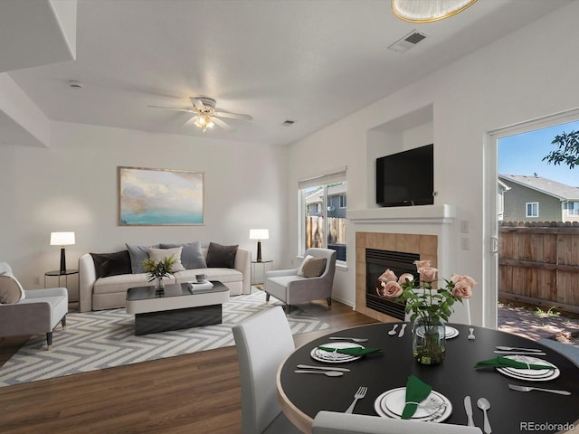 9024 Gale Blvd Unit 3, Thornton, CO 80260 - living area with wood finished floors, a tiled fireplace, and a ceiling fan