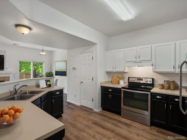 9024 Gale Blvd Unit 3, Thornton, CO 80260 - kitchen with stainless steel electric stove, under cabinet range hood, dark cabinets, a textured ceiling, and light countertops