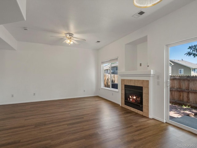 9024 Gale Blvd Unit 3, Thornton, CO 80260 - unfurnished living room featuring dark wood-style flooring, healthy amount of natural light, ceiling fan, and a tile fireplace