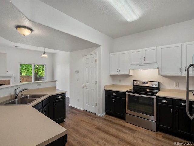 9024 Gale Blvd Unit 3, Thornton, CO 80260 - kitchen featuring stainless steel electric stove, dark cabinetry, under cabinet range hood, a textured ceiling, and light countertops