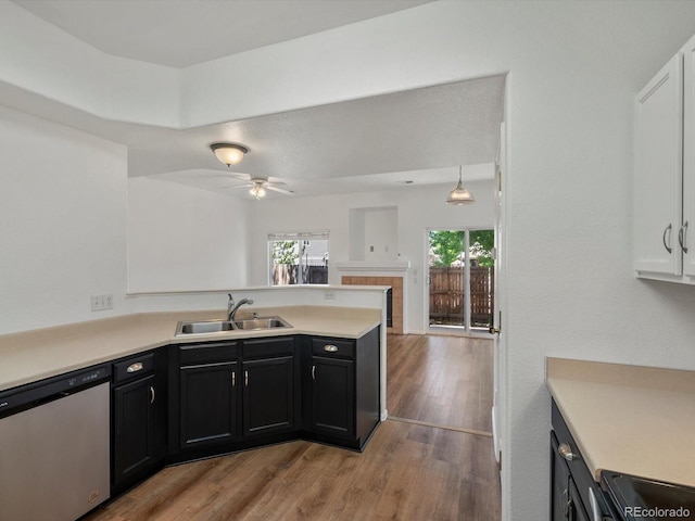 9024 Gale Blvd Unit 3, Thornton, CO 80260 - kitchen with dishwasher, dark cabinetry, a peninsula, light wood-type flooring, and light countertops