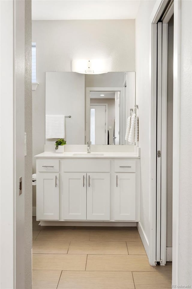 bathroom with baseboards and vanity