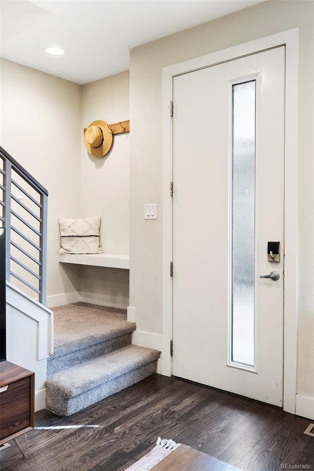 interior space featuring dark wood-style floors, stairs, and baseboards