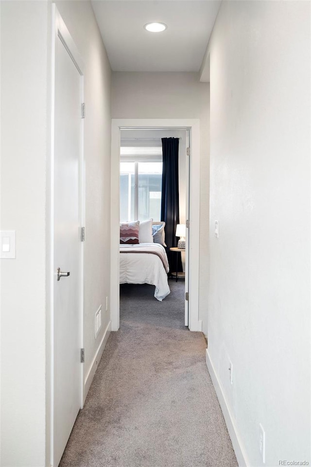 corridor featuring carpet floors and baseboards