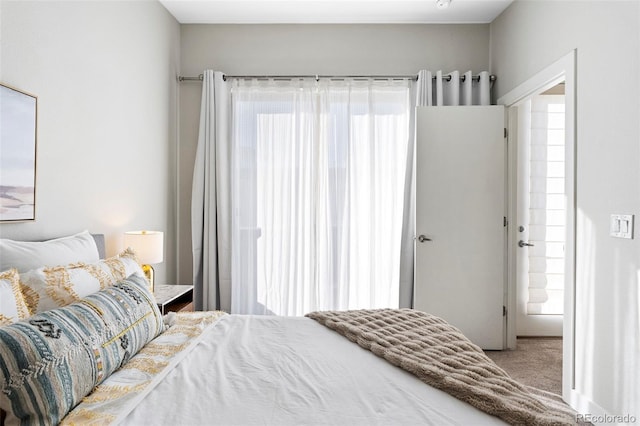 carpeted bedroom featuring multiple windows