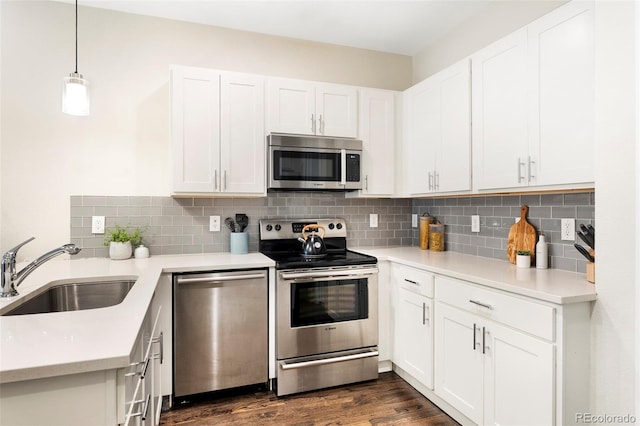 kitchen with stainless steel appliances, tasteful backsplash, a sink, and light countertops