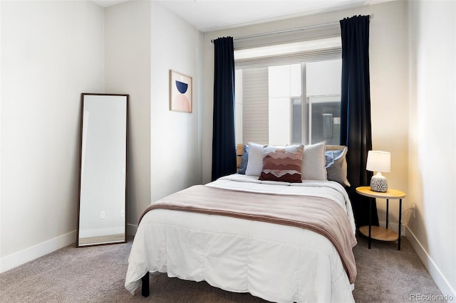 bedroom featuring carpet and baseboards