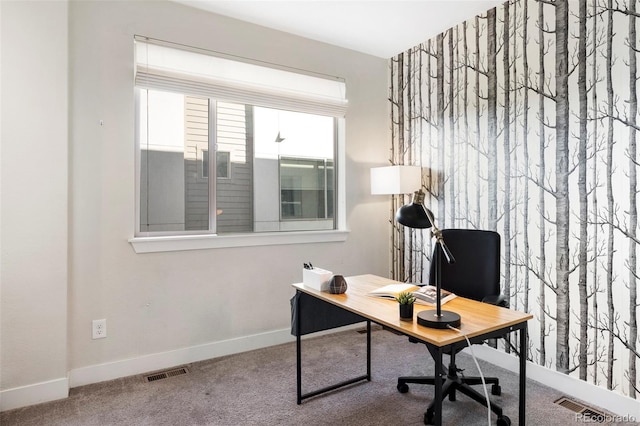 carpeted office space with visible vents and baseboards