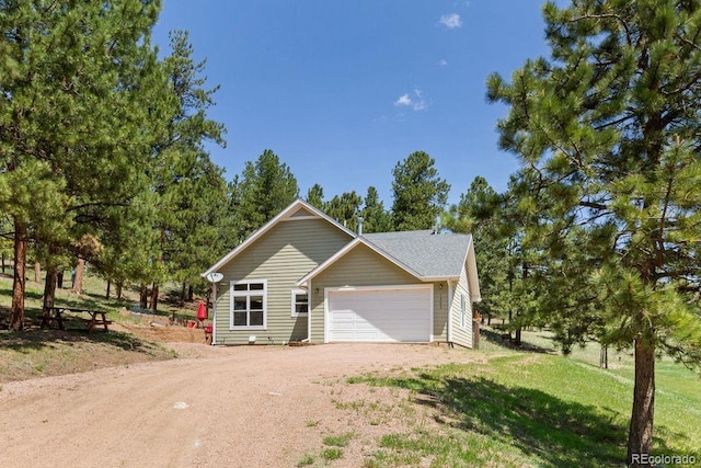 1563 Southpark Rd, Florissant, CO 80816 - view of front of home with driveway, a garage, and a front lawn