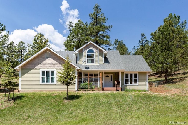 1563 Southpark Rd, Florissant, CO 80816 - view of front facade featuring covered porch, a front lawn, and a shingled roof