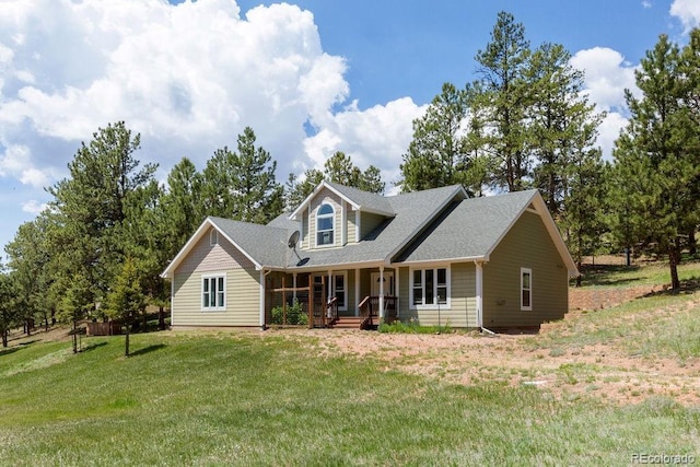 1563 Southpark Rd, Florissant, CO 80816 - new england style home featuring covered porch, a front lawn, and roof with shingles