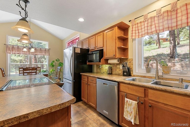 1563 Southpark Rd, Florissant, CO 80816 - kitchen with stainless steel appliances, vaulted ceiling, tasteful backsplash, tile patterned flooring, and hanging light fixtures