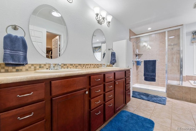 1563 Southpark Rd, Florissant, CO 80816 - full bath featuring double vanity, a stall shower, tile patterned flooring, and decorative backsplash